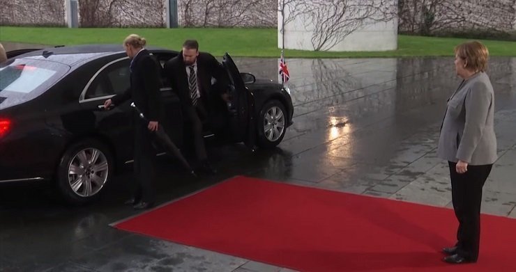 Theresa May gets locked in car while Merkel looks on (video)