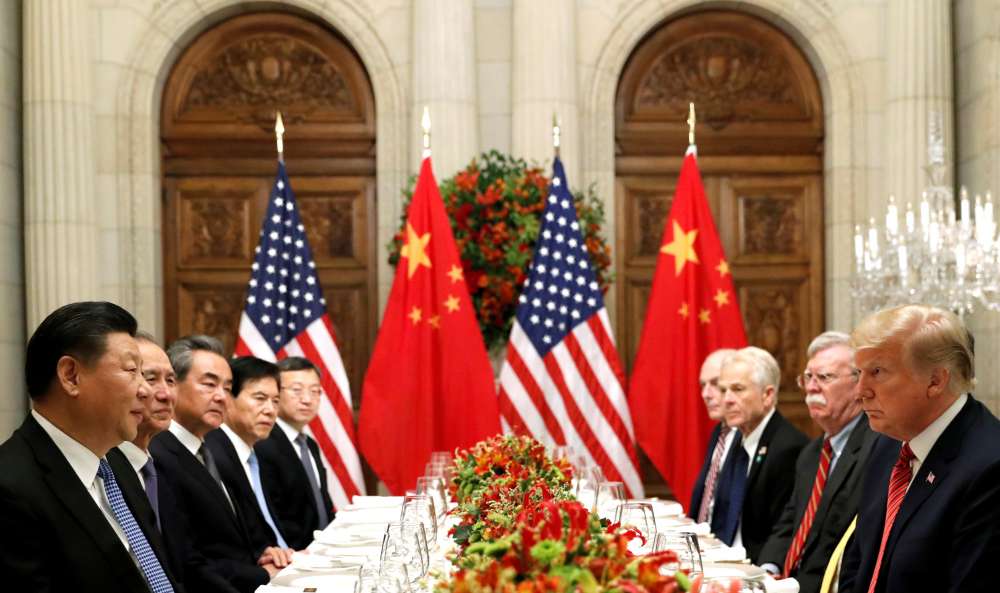 Shares sink as U.S.-China trade talks go to the wire
