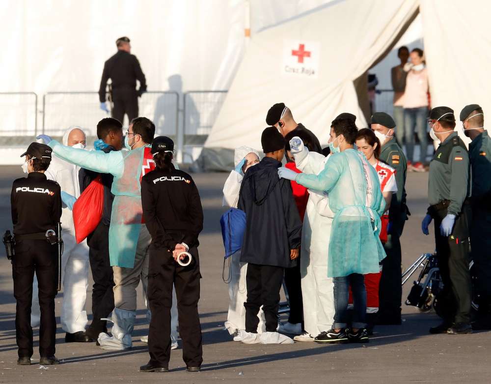 Boat migrants rocked by EU political storm arrive in Spain
