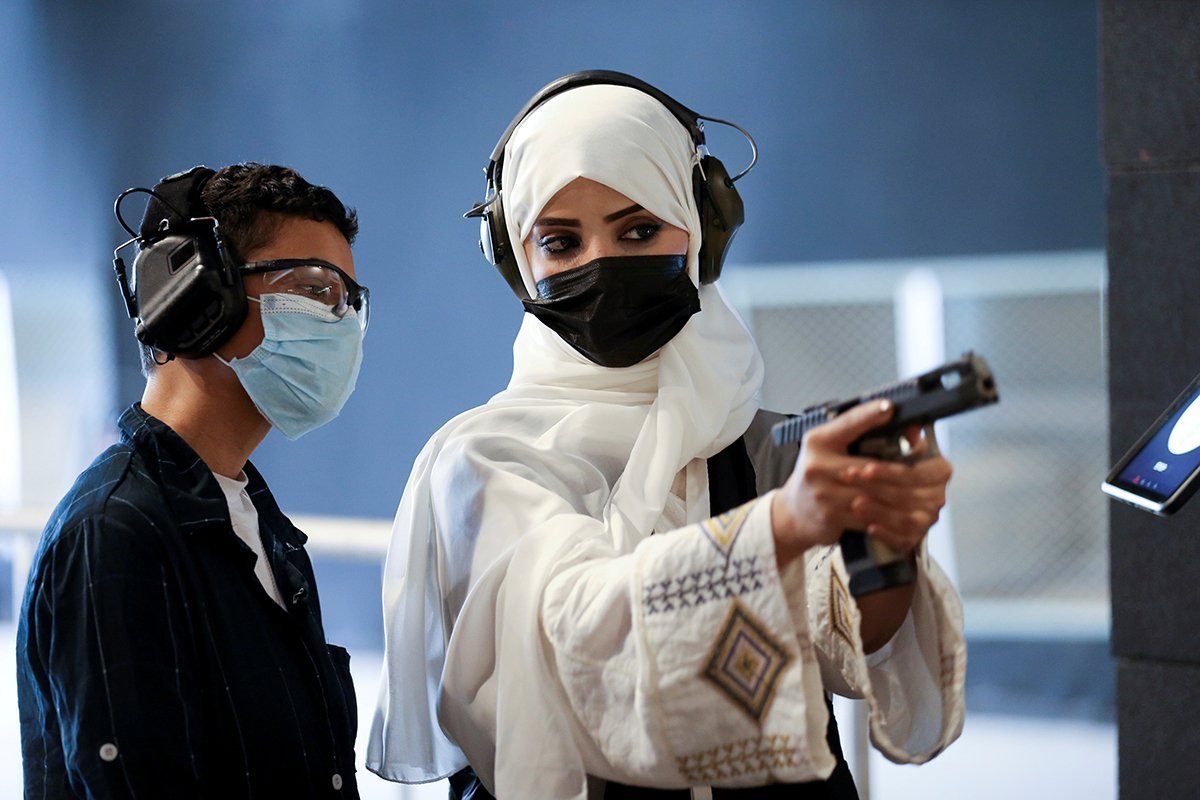Saudi Female Firearm Trainer Teaches A Saudi Boy On Safe Usage Of Weapons At The Top Gun Shooting Range