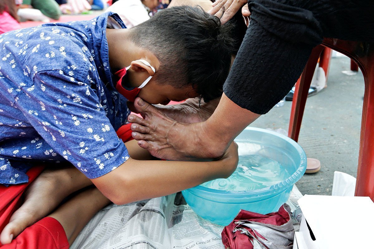 A Child Washes His Mother's Feet At An Event To Celebrate Indonesia's Mother's Day In Jakarta