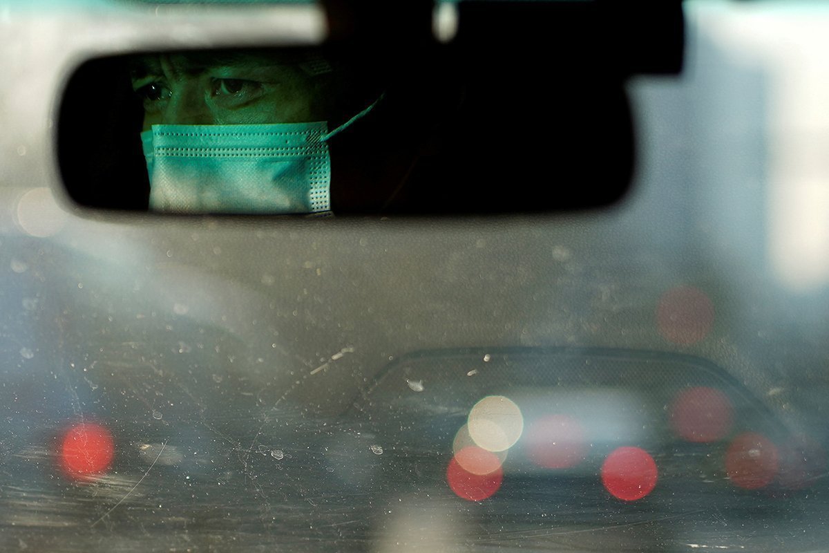 A Taxi Driver Wearing A Protective Face Mask Drives On A Street, Following New Cases Of Covid 19, In Shanghai