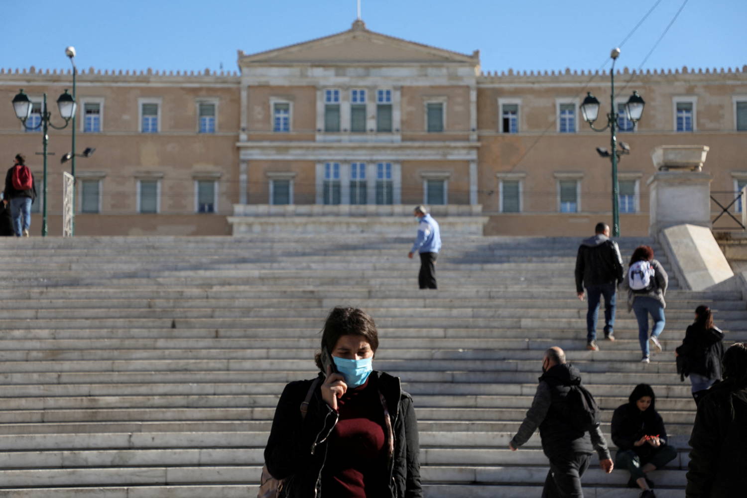 File Photo: People Wearing Protective Face Masks Against Covid 19 Walk In Syntagma Square In Athens, Greece