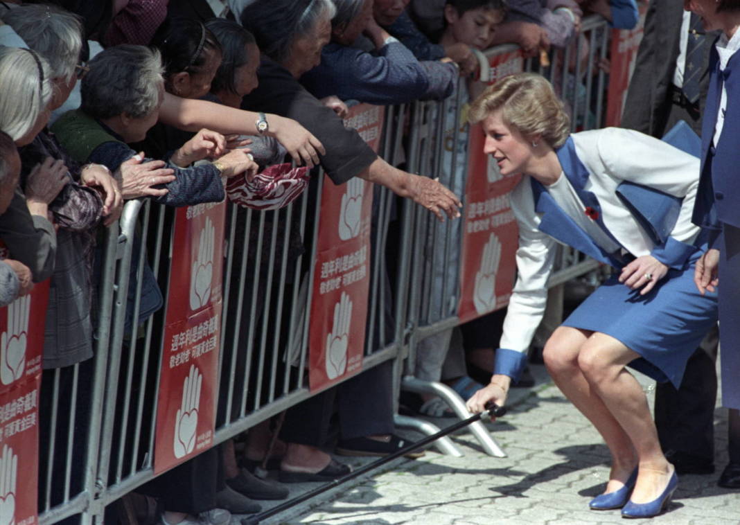 File Photo: Princess Diana, The Princess Of Wales, Stoops Down To Pick Up A Walking Stick Belonging To A Woman After She Dropped It Over The Crowd Barrier During A Walkabout In Hong Kong