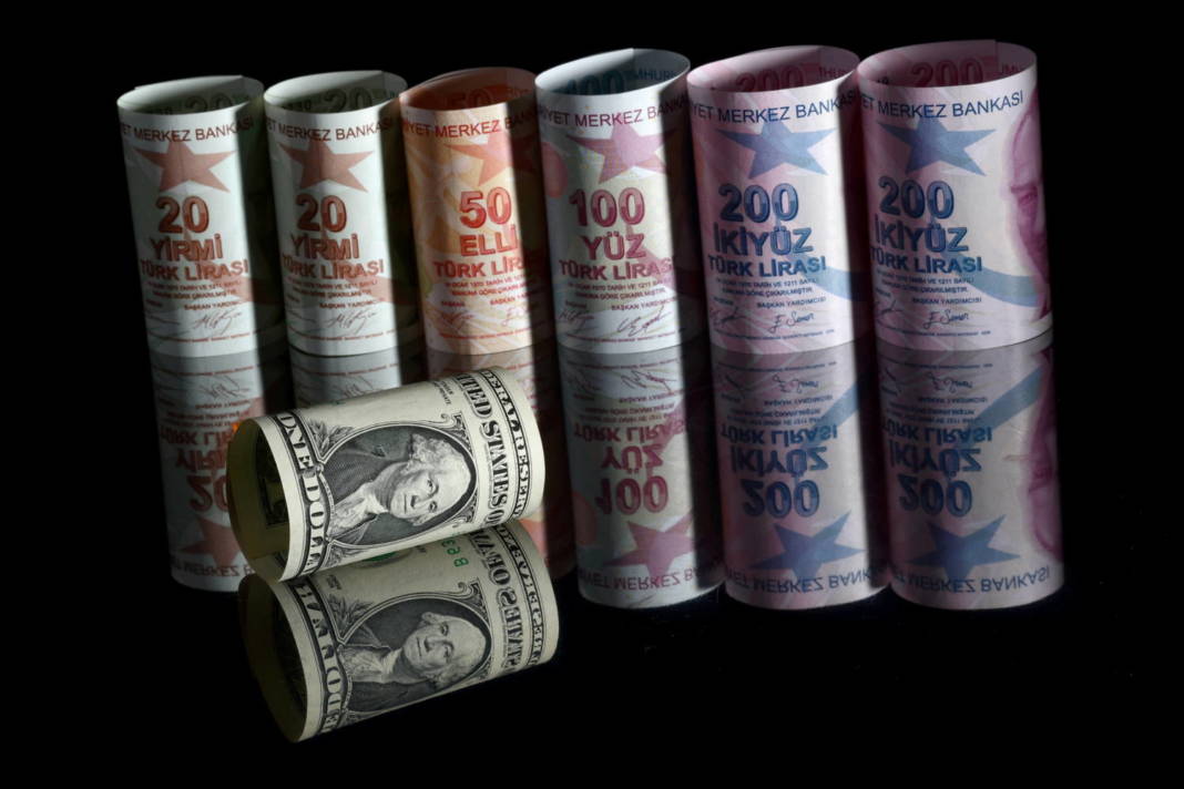File Photo: A U.s. One Dollar Banknote Is Seen Next To Turkish Lira Banknotes In This Illustration