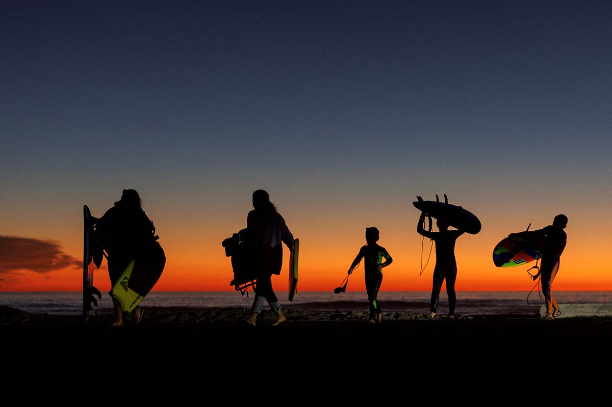 A Family Leaves The Beach After Sunset In California