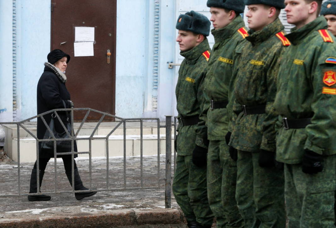 A Woman Walks Past Cadets Of The Self Proclaimed Donetsk People's Republic In In The Rebel Controlled City Of Donetsk
