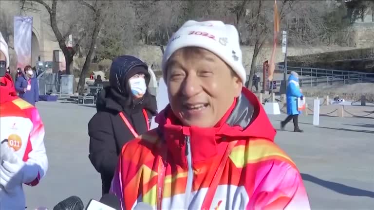 Actor Jackie Chan Carries Olympic Torch Atop Great Wall