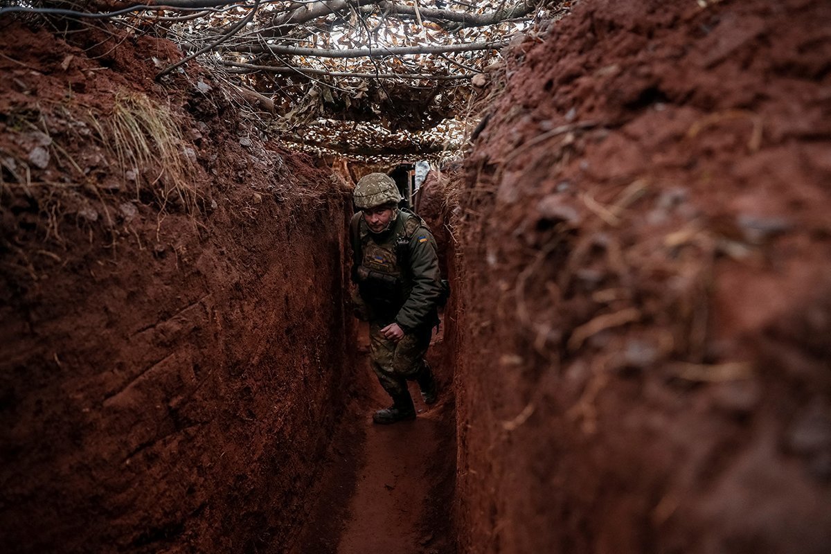 Ukrainian Service Member Walks Along A Trench At A Position On The Front Line Near The City Of Novoluhanske