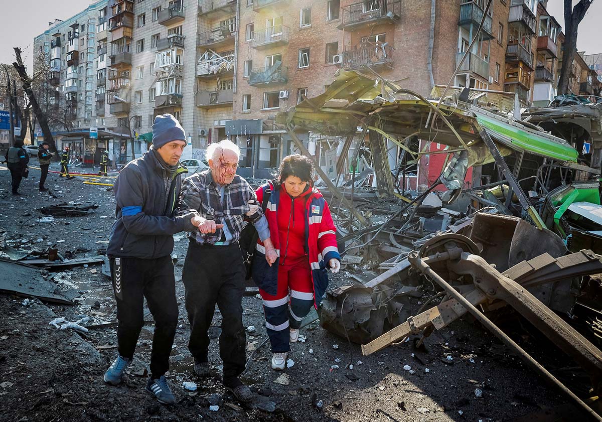 People Help A Wounded Resident Of A House Destroyed By Shelling In Kyiv