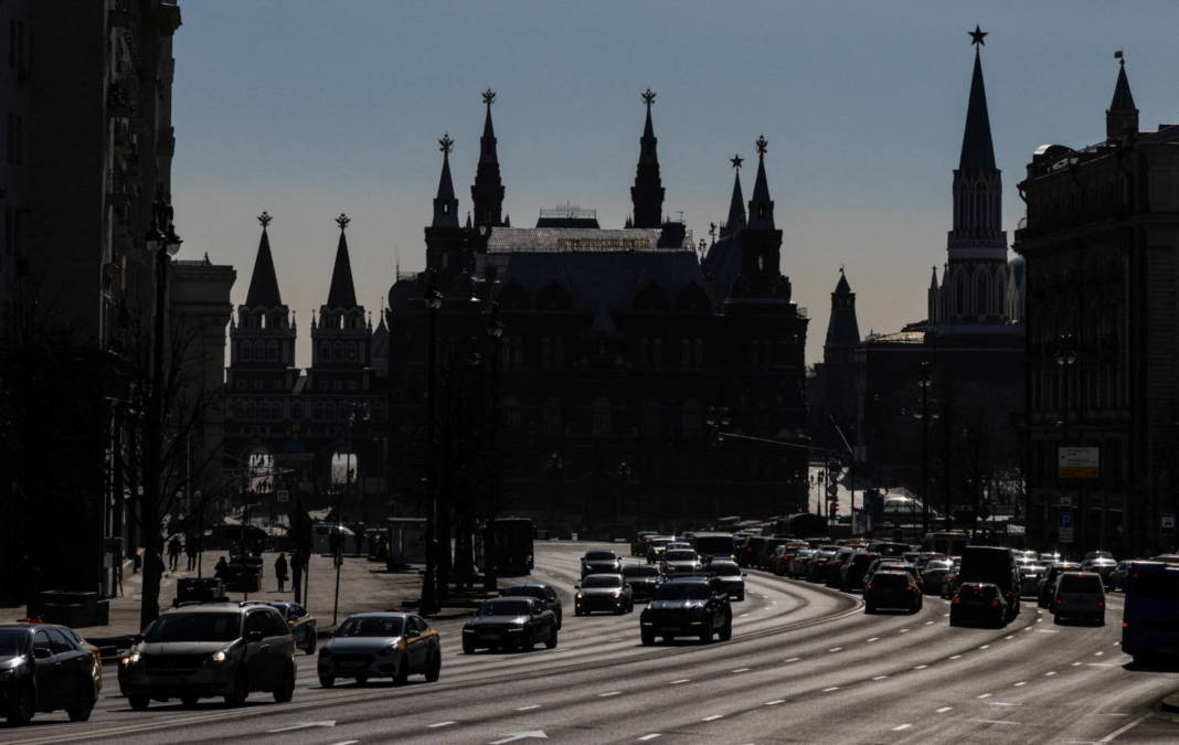 Cars Drive Along Tverskaya Street With Towers Of The State Historical Museum And Kremlin In Central Moscow