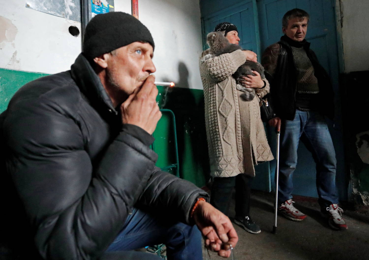 Local Residents Take Shelter From Shelling In The Entryway Of An Apartment Building In Mariupol