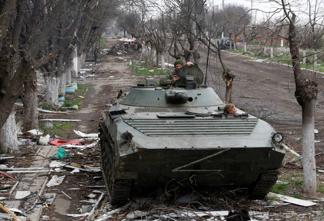 Service Members Of Pro Russian Troops Ride An Armoured Vehicle During Fighting Near Azovstal Plant In Mariupol
