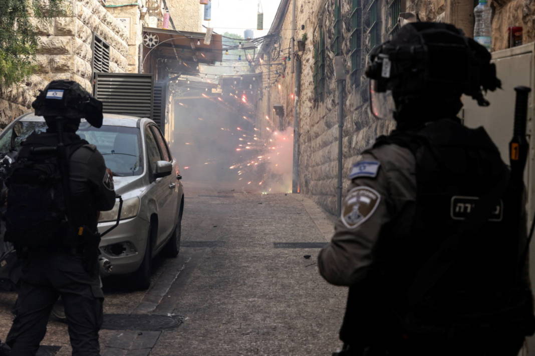 Israeli Border Police Force Stand By As Palestinian Protestors Shoot Fireworks Towards Them In An Alley In Jerusalem's Old City