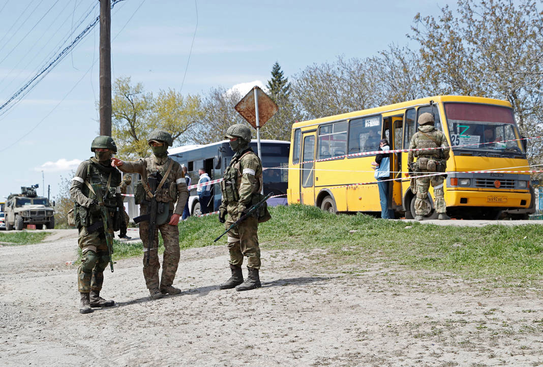 Service Members Of Pro Russian Troops Stand Guard Near A Temporary Accommodation Centre For Evacuees In Bezimenne