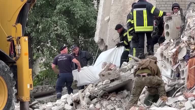 Russian Rockets Wreck Apartment Block In Ukraine's Donbas, Killing Six, Burying Dozens Under Rubble