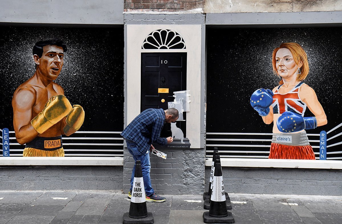 Artist Ciaran Gallagher Paints Larry The Cat Onto A Mural In Belfast City Centre