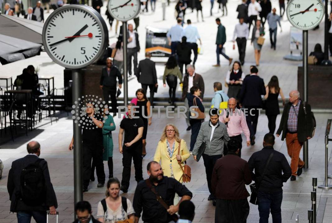 File Photo: People Walk Through The Financial District Of Canary Wharf, London, Britain 28 September 2017.