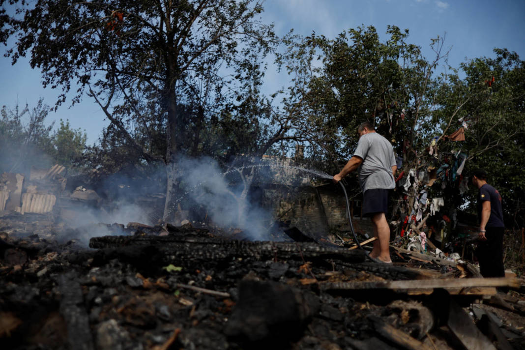 A Man Puts Out Fire In His House After A Russian Strike In The City Of Slovyansk