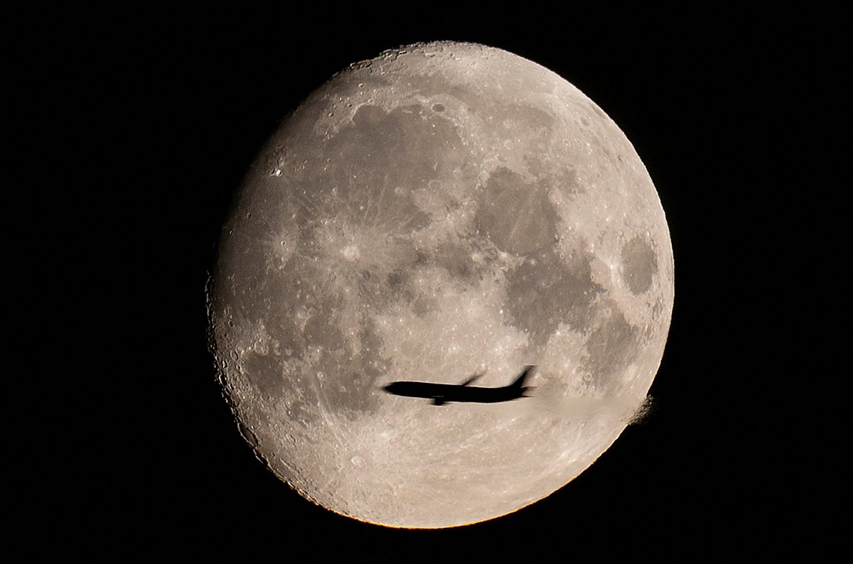 A Passenger Plane Is Seen With The Full Moon Behind In Moscow