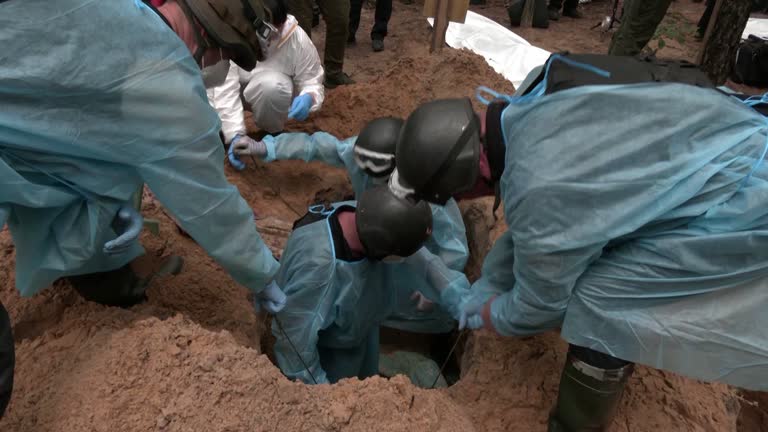 Ukraine Authorities Conduct Exhumation At Mass Grave Site In Izium