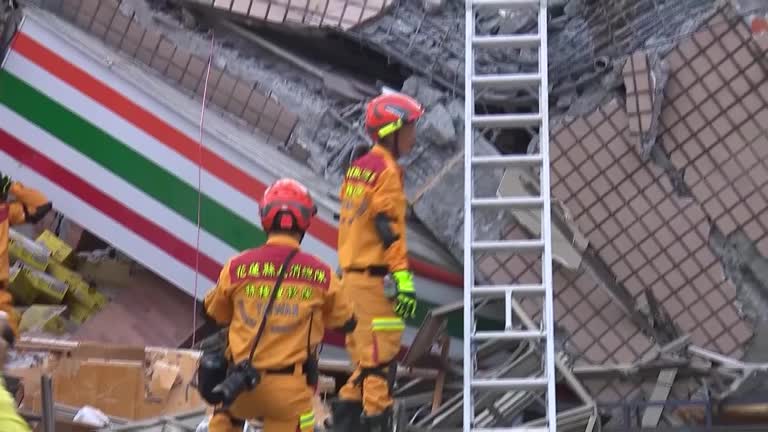 Rescue Operation Underway At Building Toppled By Taiwan Quake