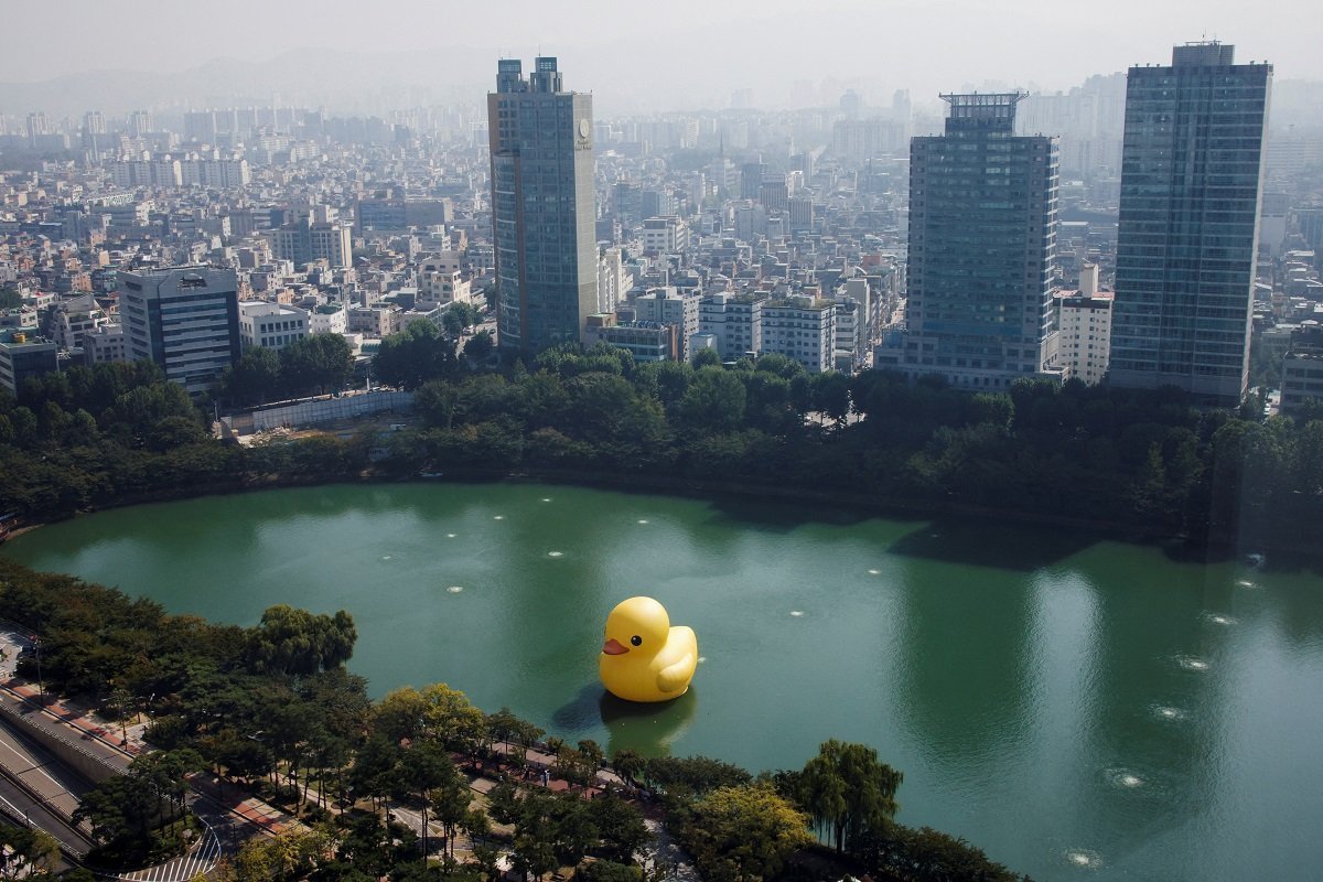 A Giant Inflatable Rubber Duck Installation By Dutch Artist Florentijn Hoffman Floats On Seokchon Lake In Seoul