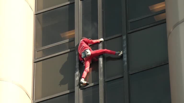 French 'spiderman' Climbs Paris Tower To Urge Easing Of Petrol Strikes, Social Dialogue