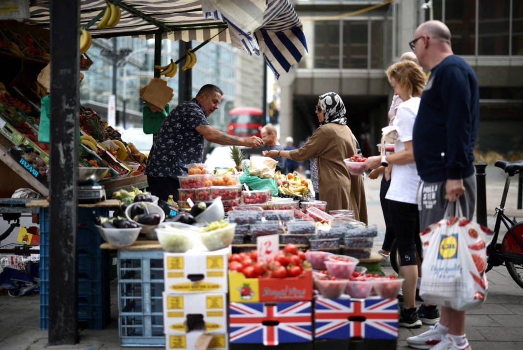 File Photo: A Person Buys Produce From A Fruit And Vegetable Market Stall In Central London