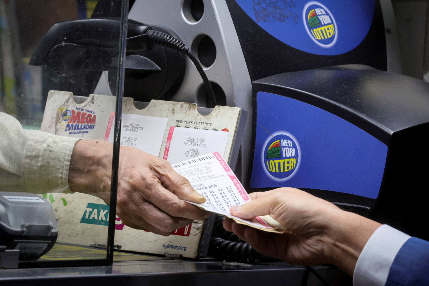 File Photo: Customer Buys Powerball Lottery Ticket In New York