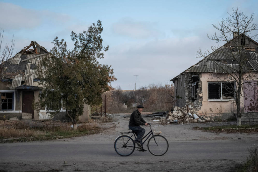 A Local Resident Rides A Bike Near Destroyed Houses In The Village Of Arkhanhelske, Kherson Region