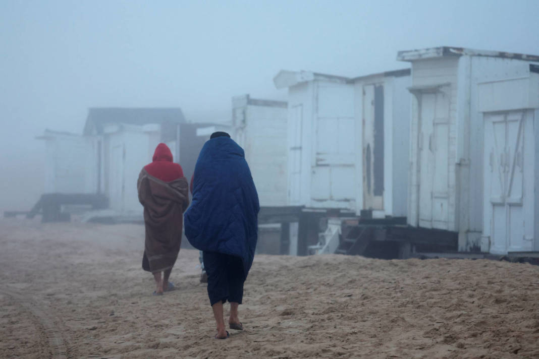 Two Migrants From Syria Walk On The Beach In Bleriot Plage Near Calais