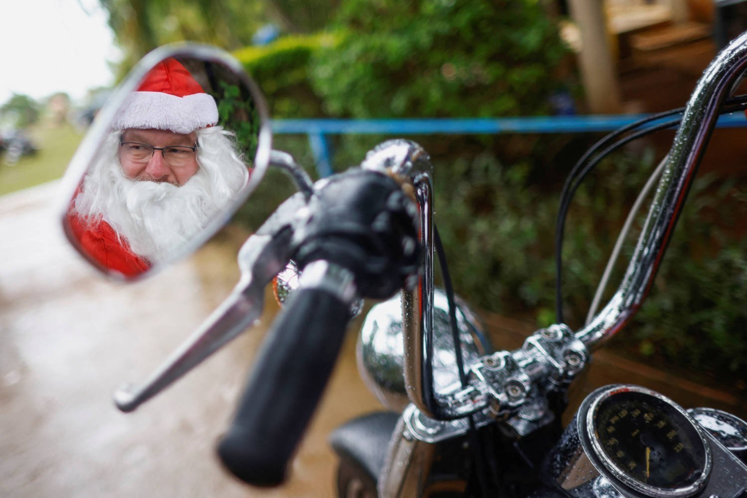 Helton Garcia Dressed As santa claus rides On A motorcycle before Distributing Small Presents To Children In A Rural School In Santo Antonio Do Descoberto, State Of Goias