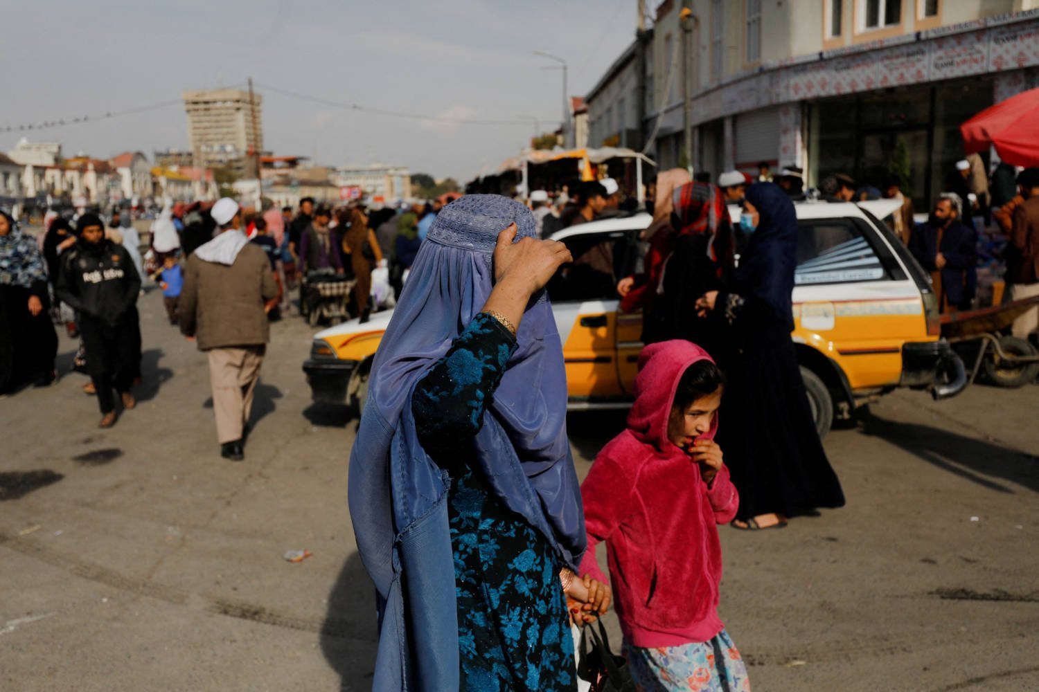 File Photo: An Afghan Woman And A Girl Walk In A Street In Kabul