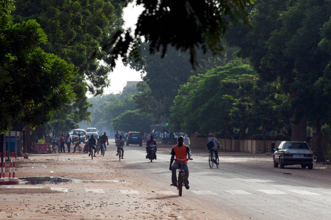 File Photo: People Ride Bicycles And Motorcycles On A Street In Ouagadougou