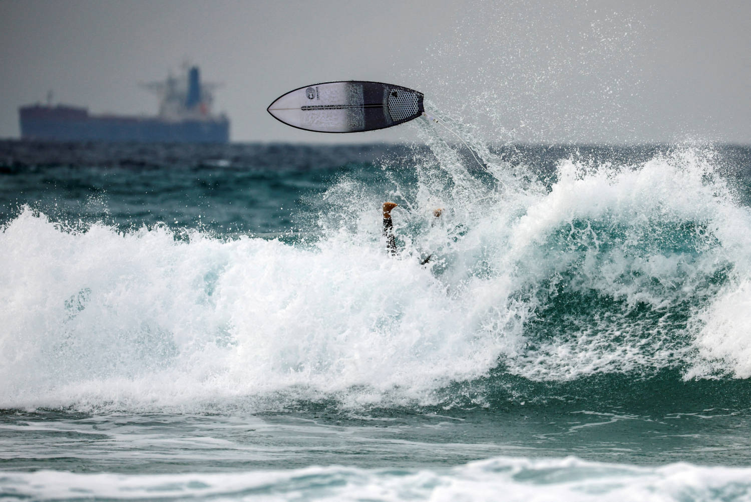 A Surfer Rides The Waves On The Mediterranean Sea Shore Of Ashkelon