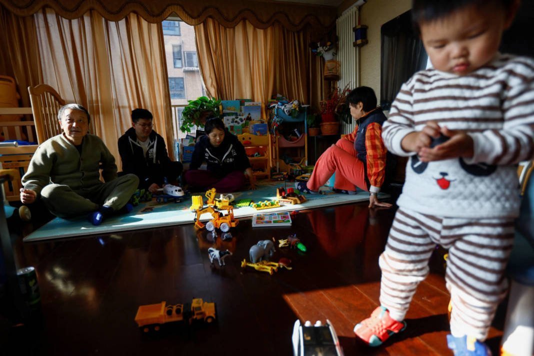 Tang Huajun, Ang Ran And Her Parents Sit Near Their 2 Year Old Son Tang Ziang At Their Home In Beijing