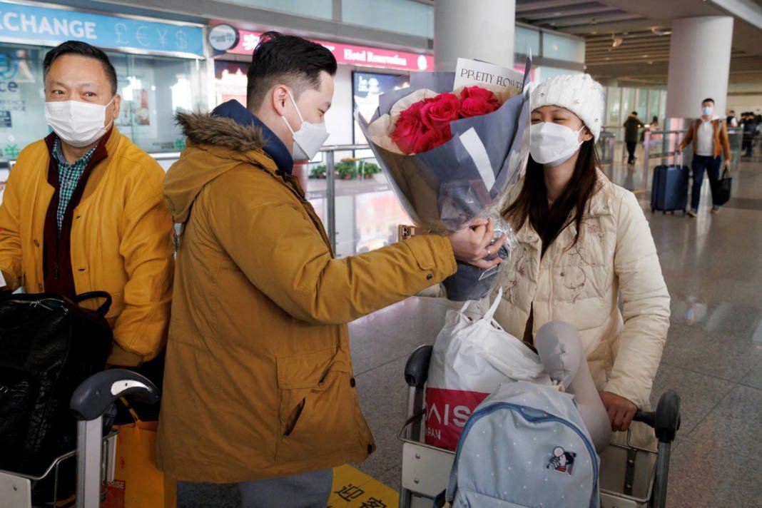 A Man Hands Flowers To A Woman After She Came Through The International Arrivals Gate At Beijing Capital International Airport After China Lifted The Covid 19 Quarantine Requirement For Inbound Travellers In Beijing