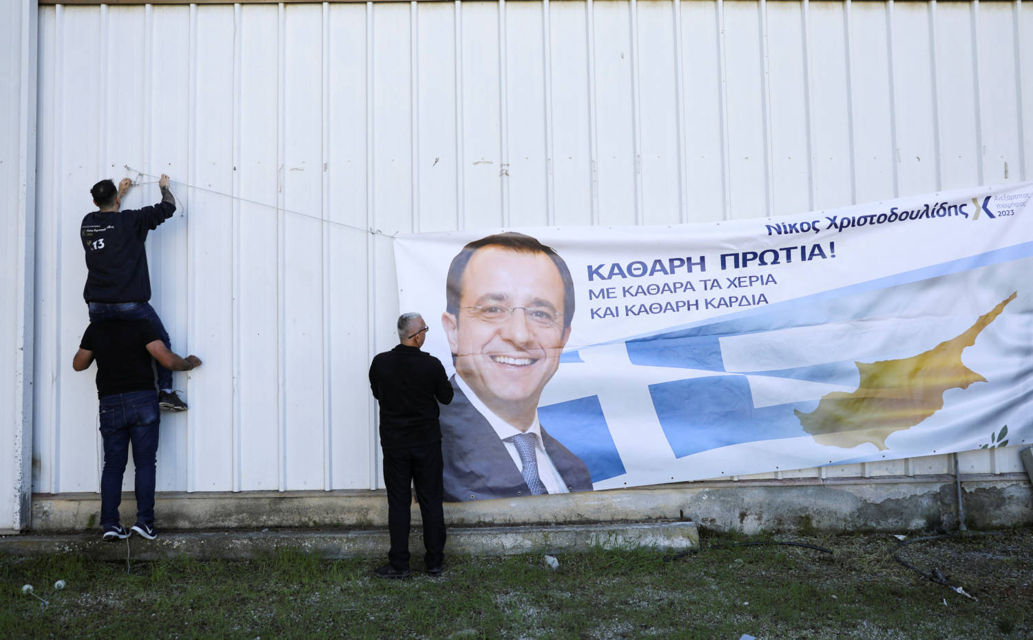 Supporters Hang A Banner Of Cyprus Presidential Candidate Nikos Christodoulides During A Pre Election Rally In Nicosia