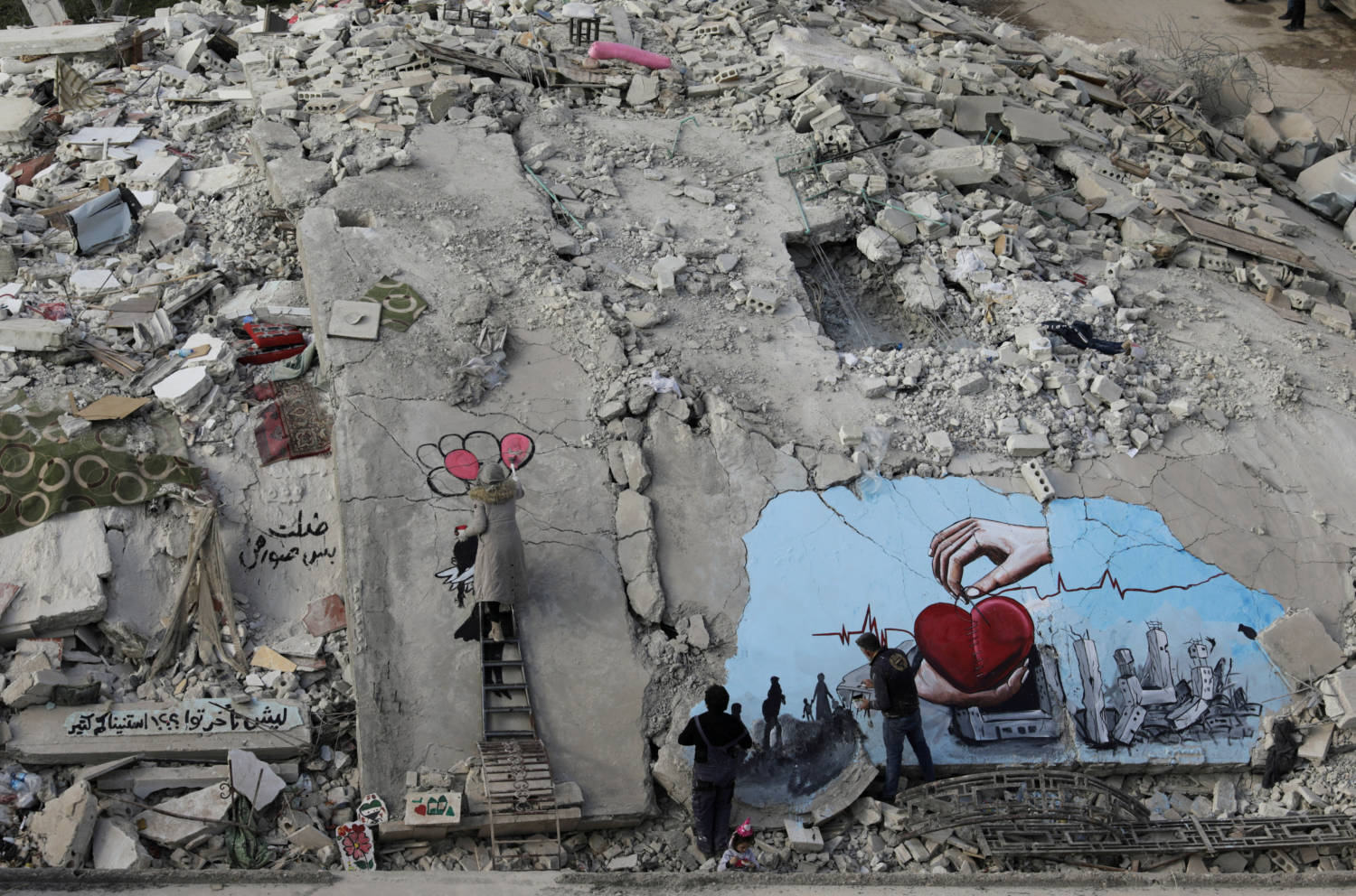 Syrian Artists Aziz Asmar And Salam Hamed Paint Street Art On Rubble Of Damaged Buildings In The Rebel Held Town Of Jandaris