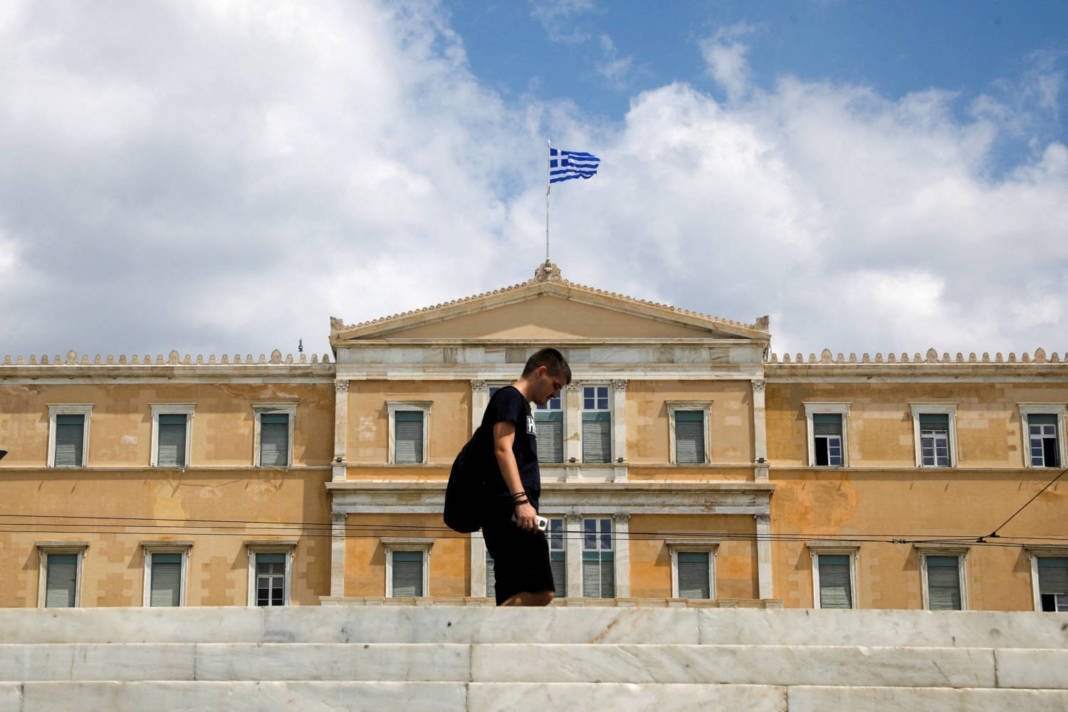 File Photo: A Man Passes In Front Of The Greek Parliament Building In Athens