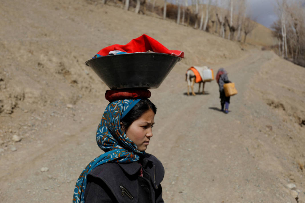 An Afghan Girl Carries Washed Clothes On Her Head In Bamiyan