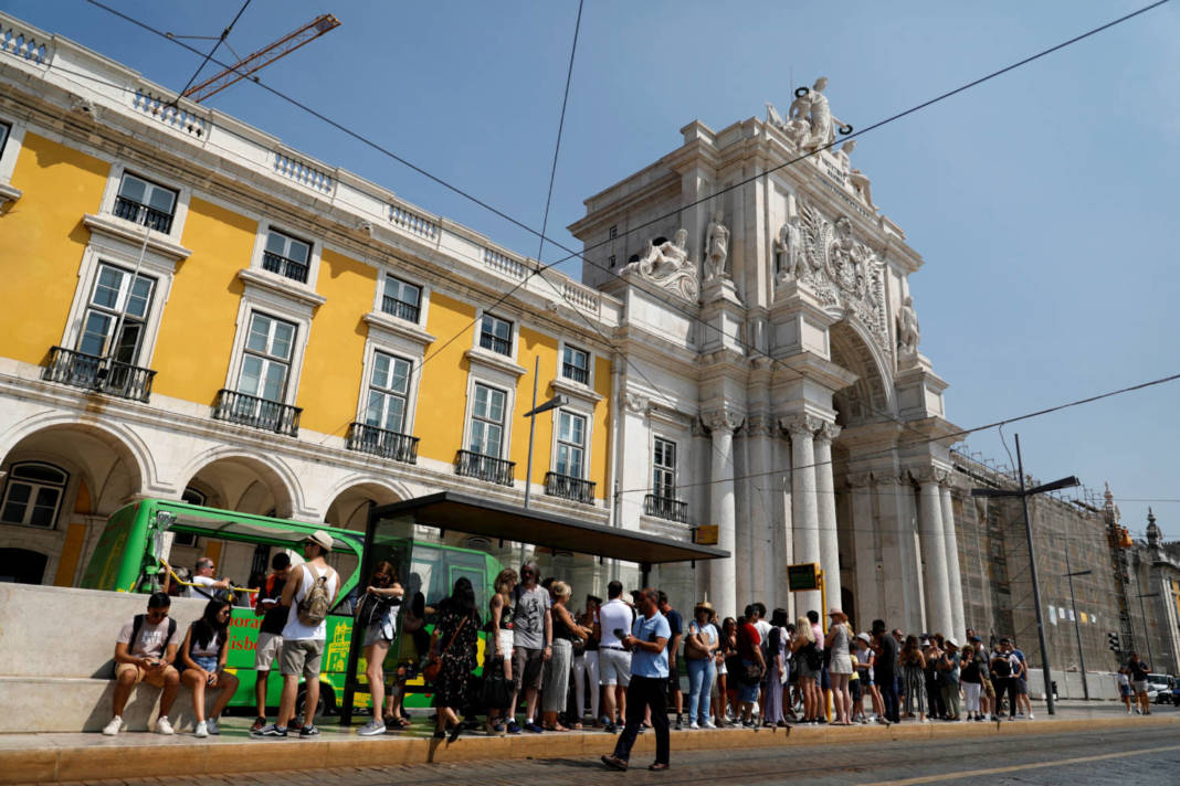 File Photo: Tourists Wait For A Tram At Comercio Square In Downtown Lisbon
