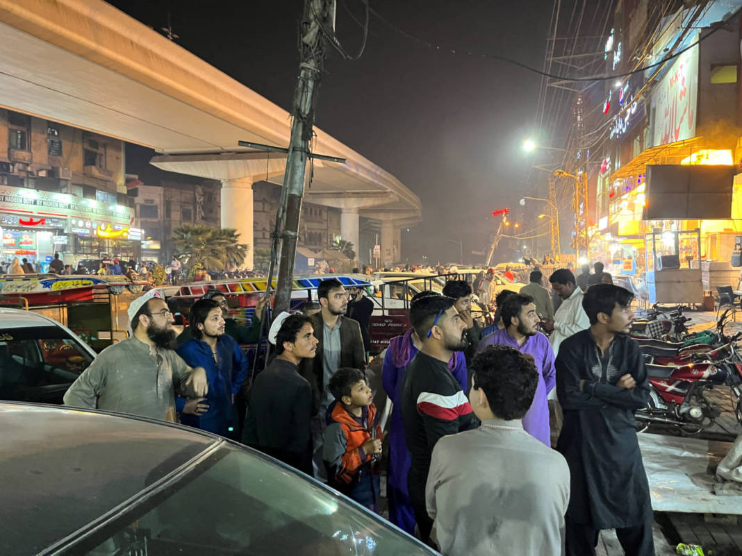 People Come Out Of A Restaurant After A Tremor Was Felt In Lahore