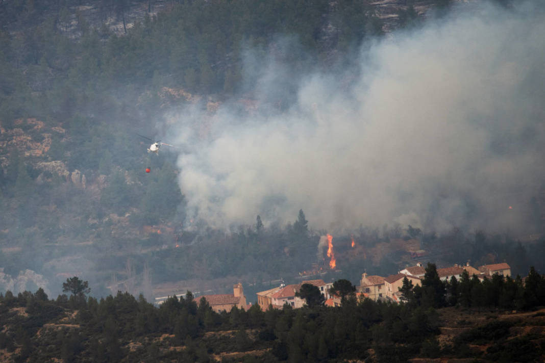 A Helicopter Drops Water On A Wildfire In Los Calpes