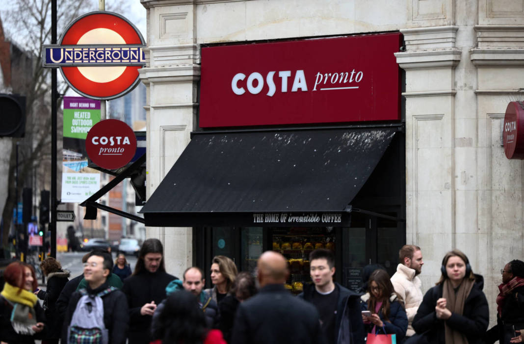 People Walk Outside A Costa Coffee Shop In London