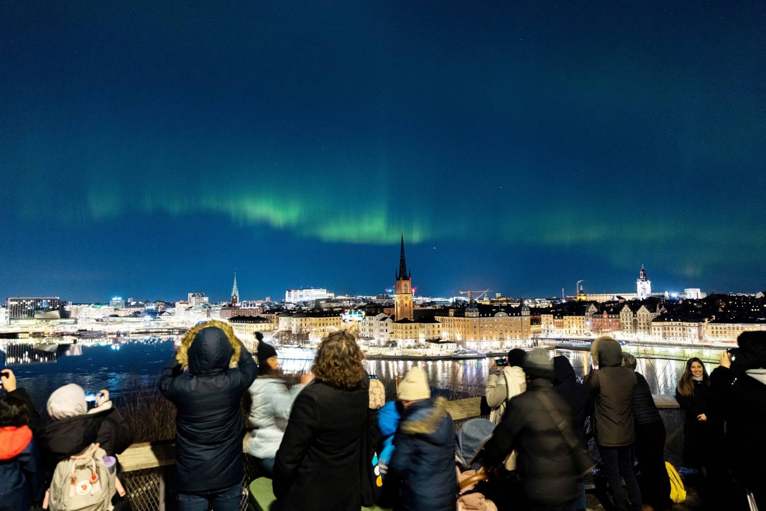 People Watch The Northern Lights, Aurora Borealis, In Central Stockholm