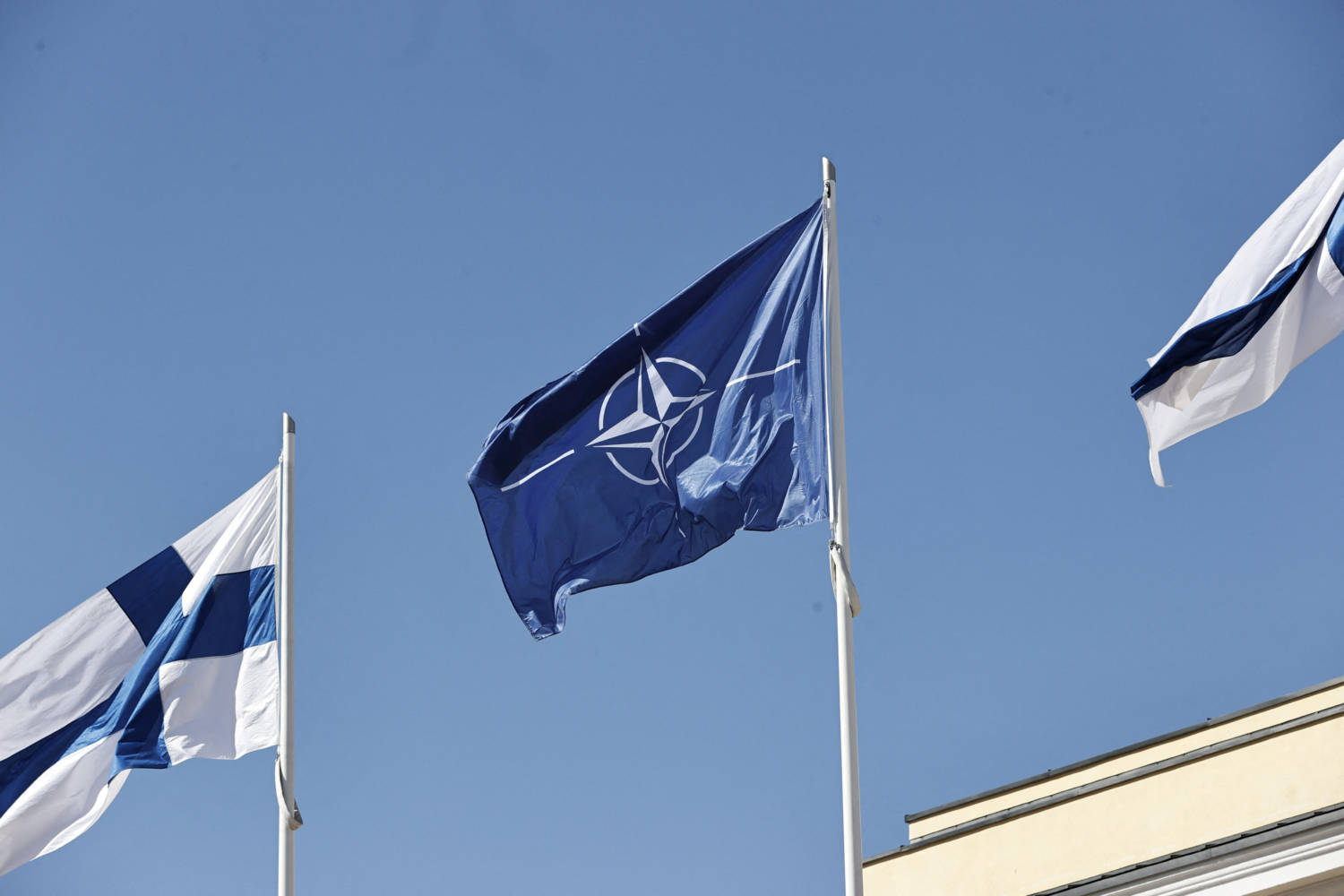 Finnish And Nato Flags Flutter At The Courtyard Of The Foreign Ministry In Helsinki