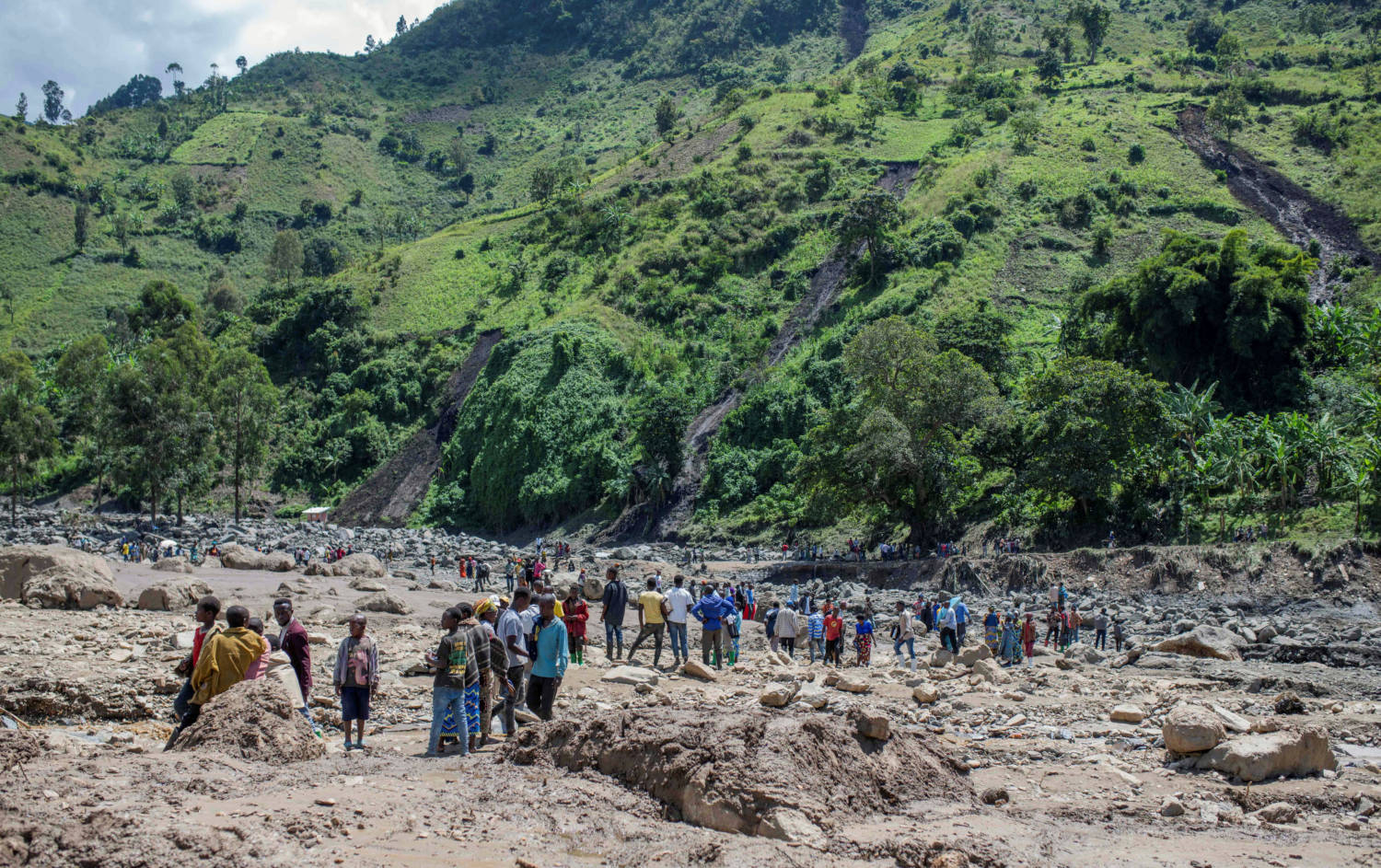Congolese Civilians Gather After The Death Of Their Family Members Following Rains That Destroyed Buildings And Forced Aid Workers To Gather Mud Clad Corpses Into Piles In The Village Of Nyamukubi