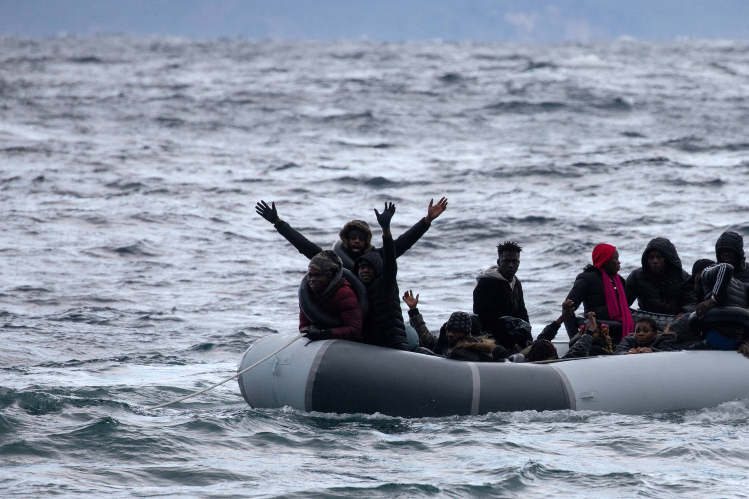 File Photo: Migrants From Sub Saharan African Countries On A Dinghy React As They Are Towed By A Rescue Boat During Their Effort To Cross Part Of The Aegean Sea From Turkey To The Island Of Lesbos
